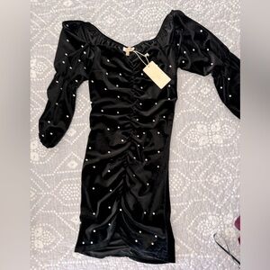 A beautiful long sleeve velvet black evening dress with white pearls